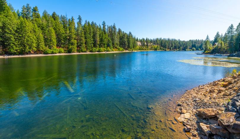 Spirit Lake Idaho shoreline with forested hills and calm water
